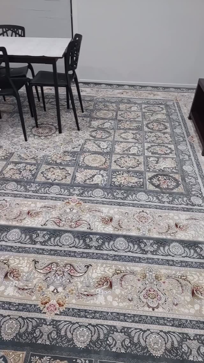 A Persian rug and floor seating in a styled room