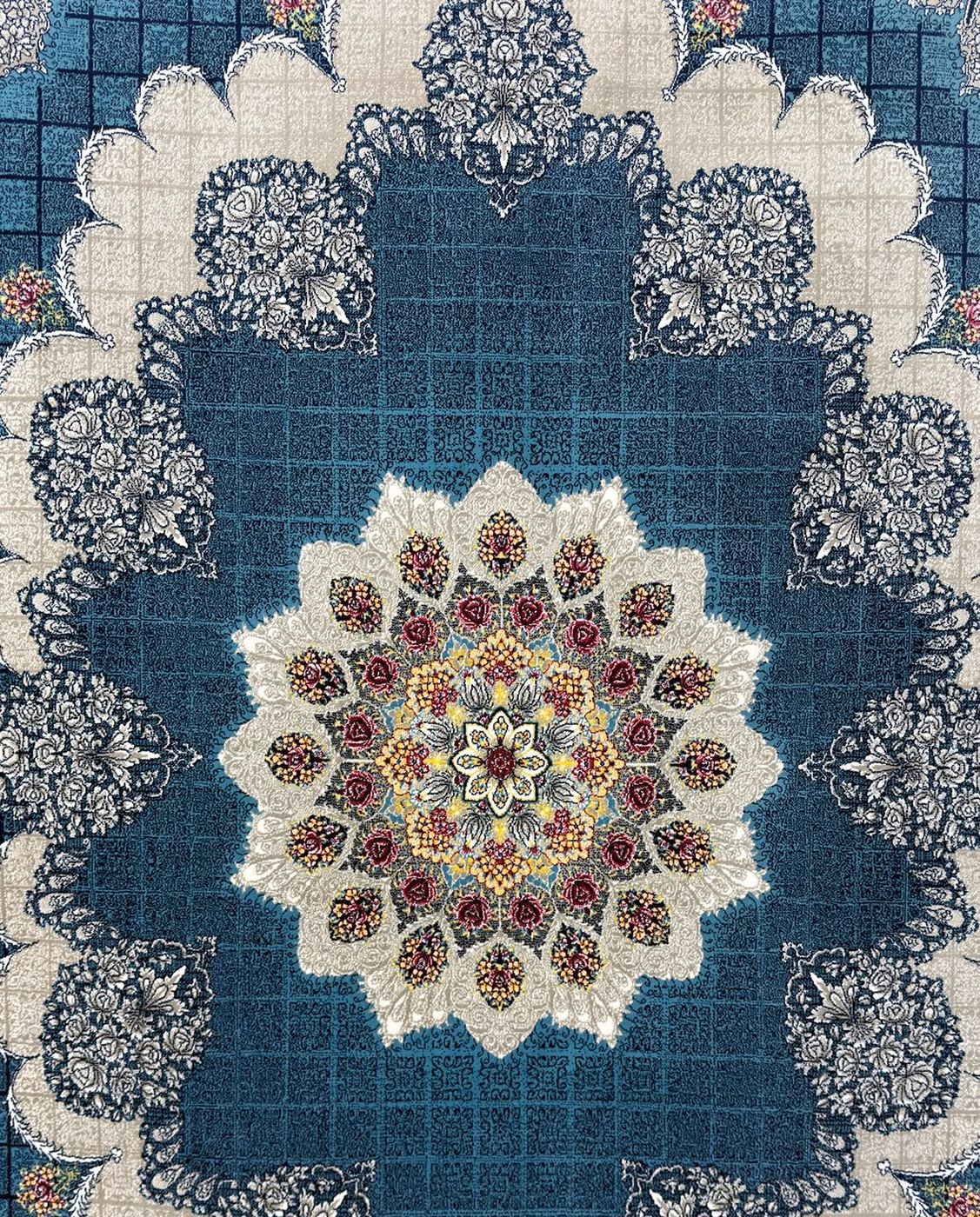 A 700 reed Persian rug on the showroom floor, a deep blue field under a cream and rose medallion